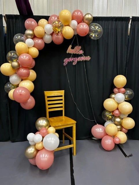 Pink and gold balloon garland with a hello gorgeous neon sign
